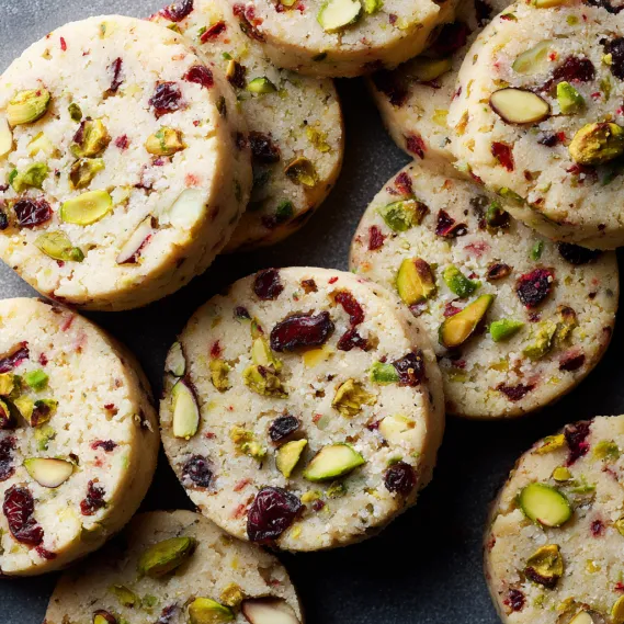 A stack of cookies with nuts and fruit.