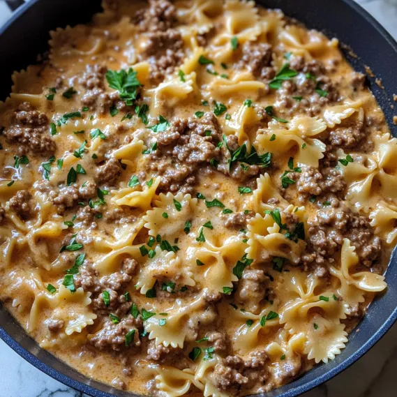 A bowl of pasta with meat and cheese.