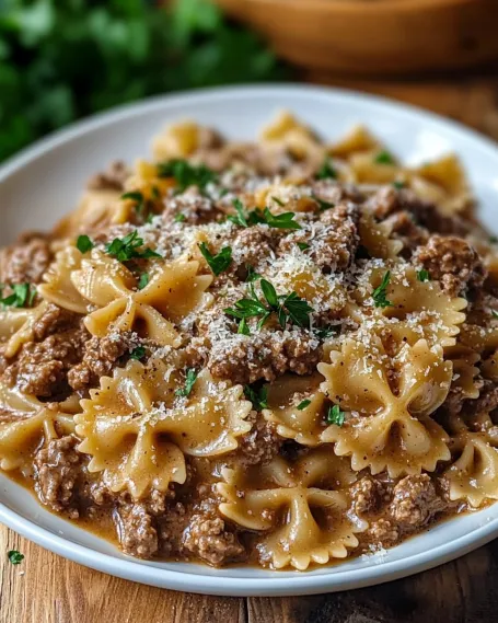 A bowl of pasta with meat and cheese.