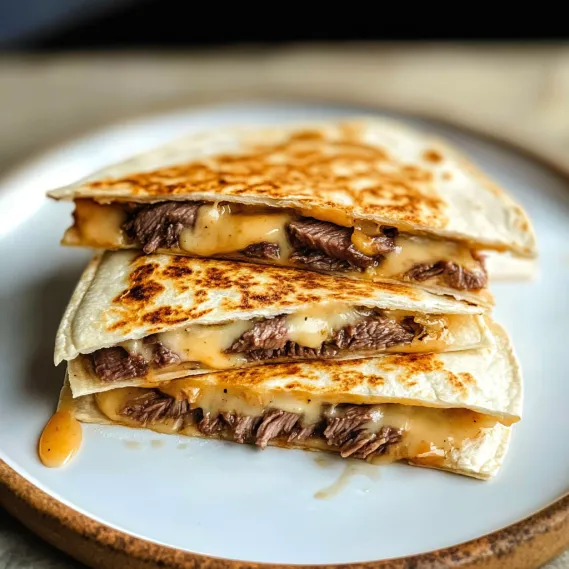 A stack of beef tacos on a plate.