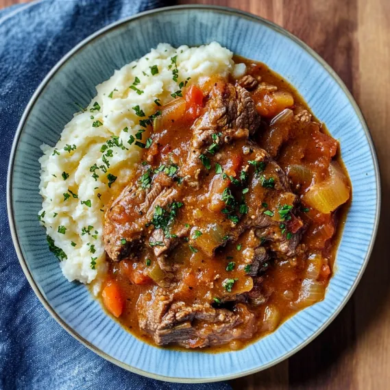 A bowl of meat and potatoes.