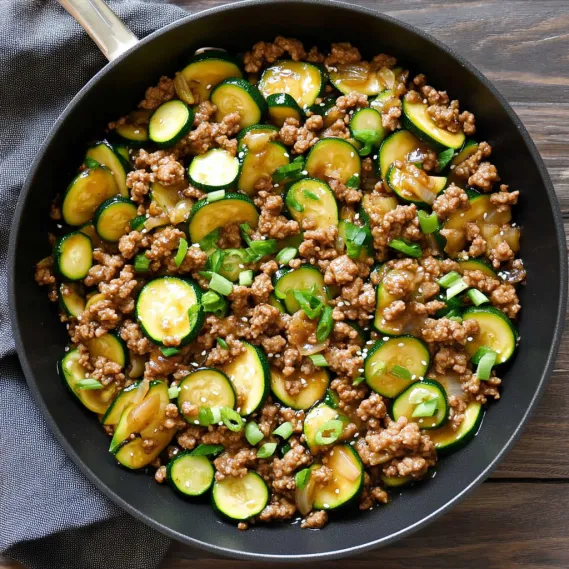 A black pan with meat and vegetables.