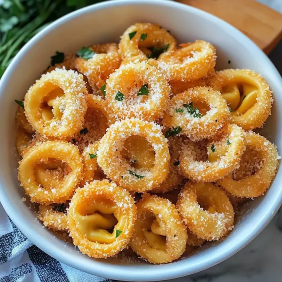 A bowl of pasta with cheese and herbs.