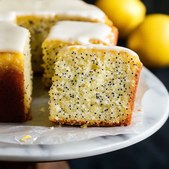 A slice of cake with white frosting and black seeds.