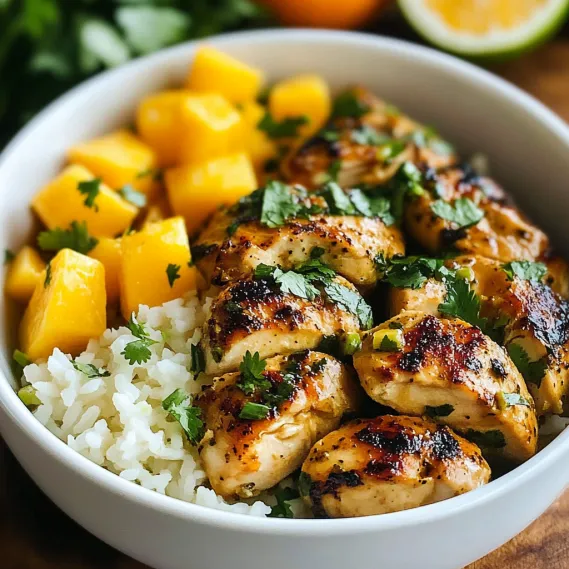 A bowl of food with rice, chicken, and pineapple.
