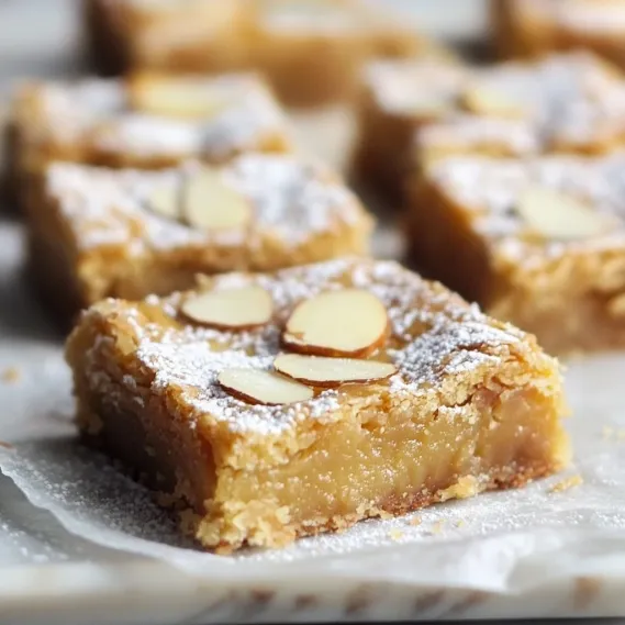 A piece of cake with almonds on top.