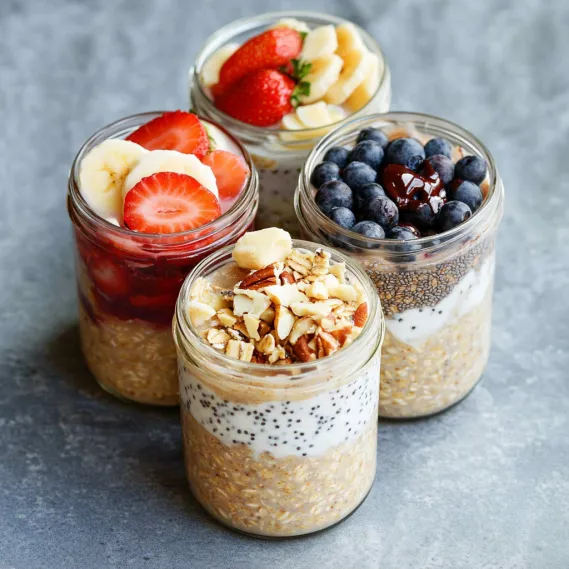 Four jars of food are displayed on a table.
