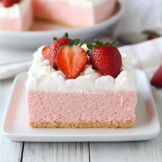 A slice of cake with strawberries on top.