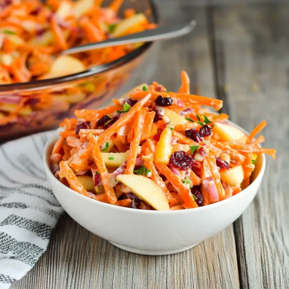 A bowl of carrots and apples.