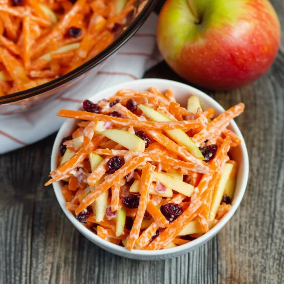 A bowl of carrots and apples.