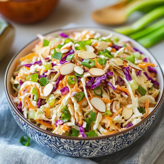 A bowl of coleslaw with a spoon.