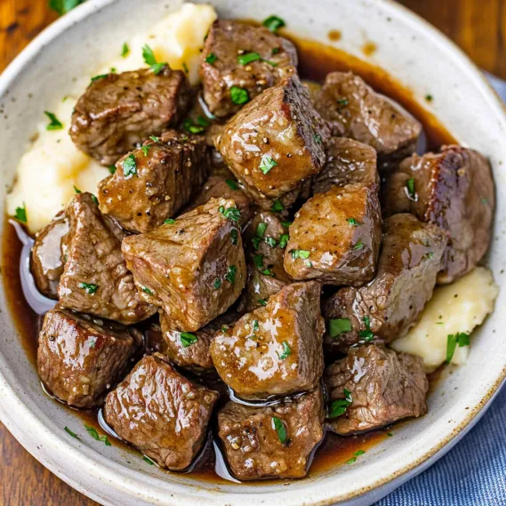 A bowl of meat and potatoes.