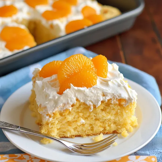 A slice of cake with white frosting and orange slices on top.