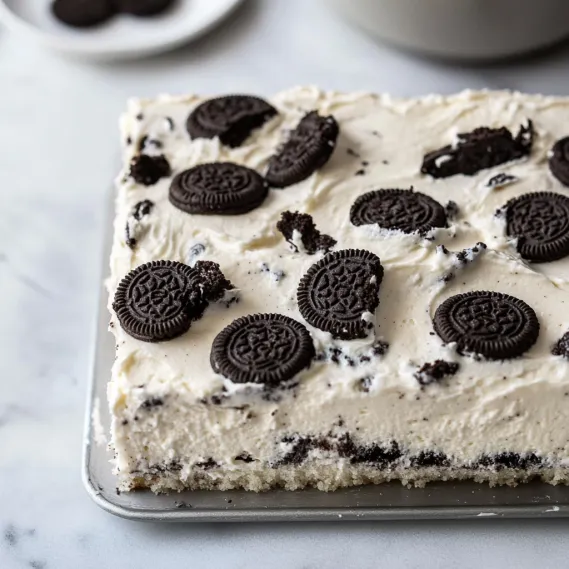 A slice of cake with chocolate and white frosting.