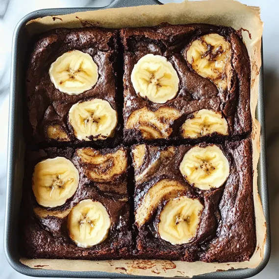 A square of chocolate cake with bananas.