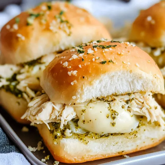 A plate of sandwiches with chicken and cheese.