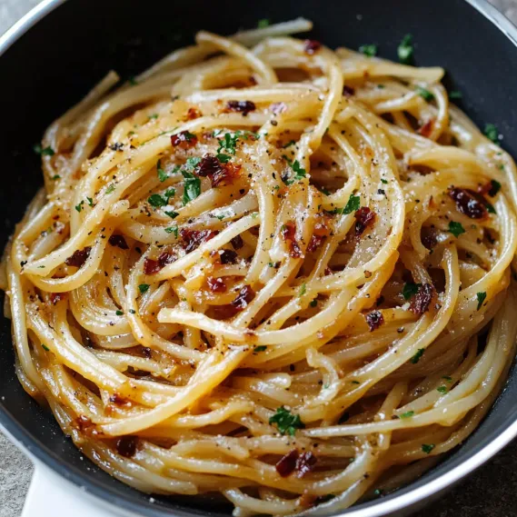 A bowl of pasta with cheese and herbs.