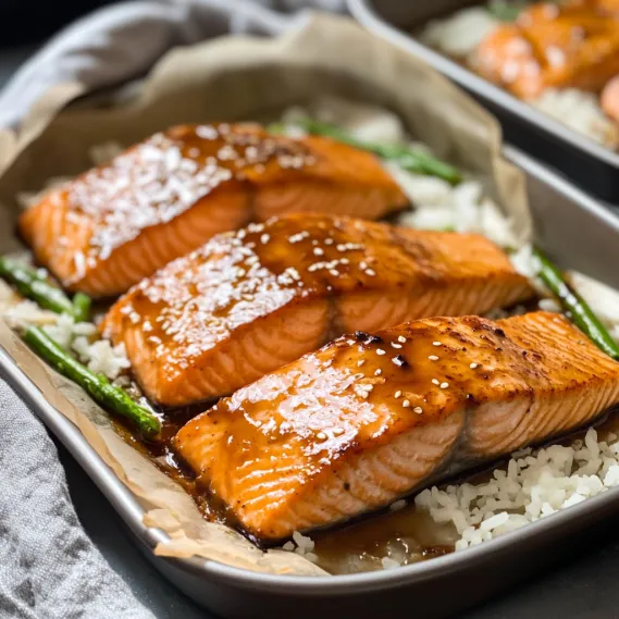 A pan of fish with rice and seasoning.