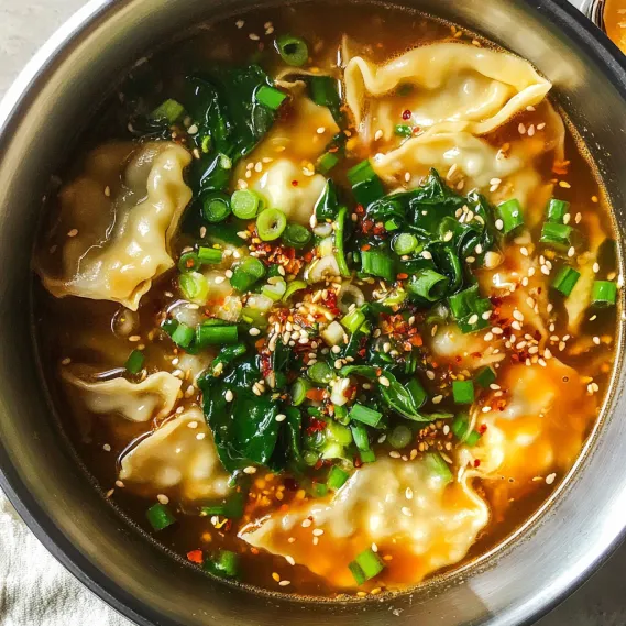 A bowl of soup with vegetables and noodles.
