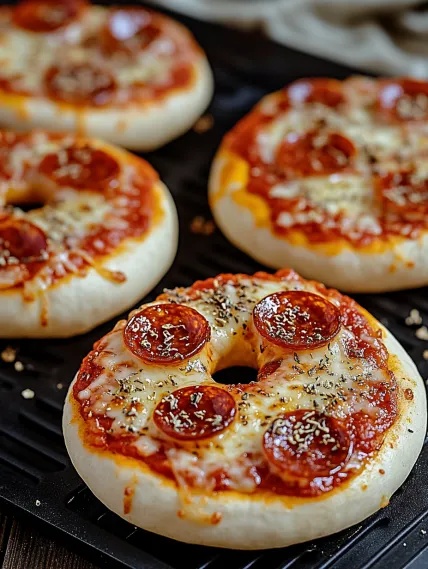 A pizza bagel with pepperoni and cheese.