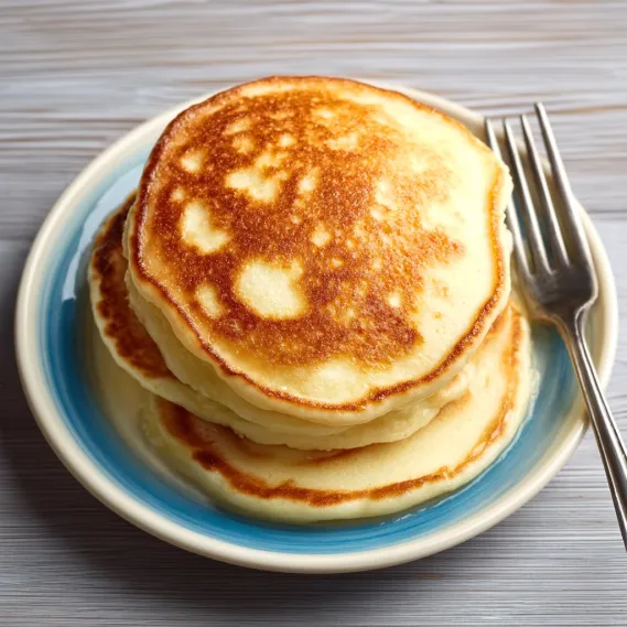 A stack of pancakes on a plate.