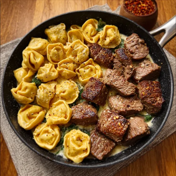A plate of food with pasta and meat.