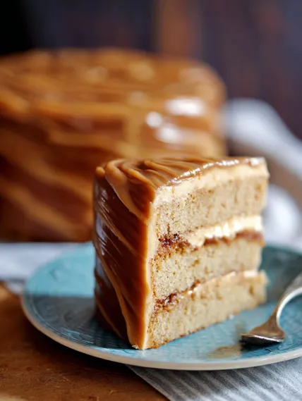 A slice of cake with caramel frosting.