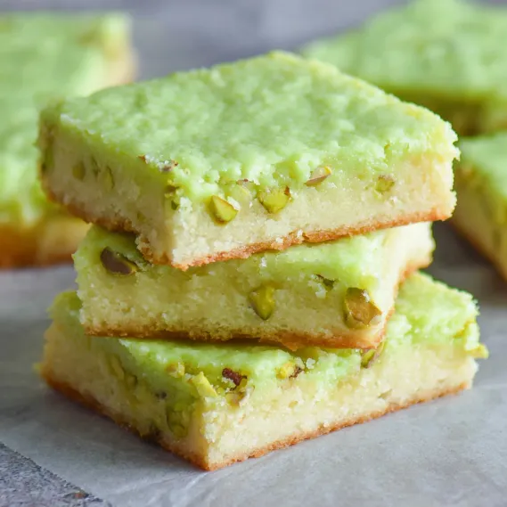 Green cake on a table.