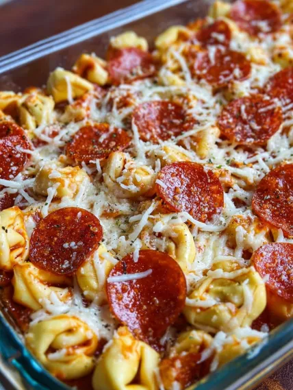 A dish of pasta with pepperoni and cheese.