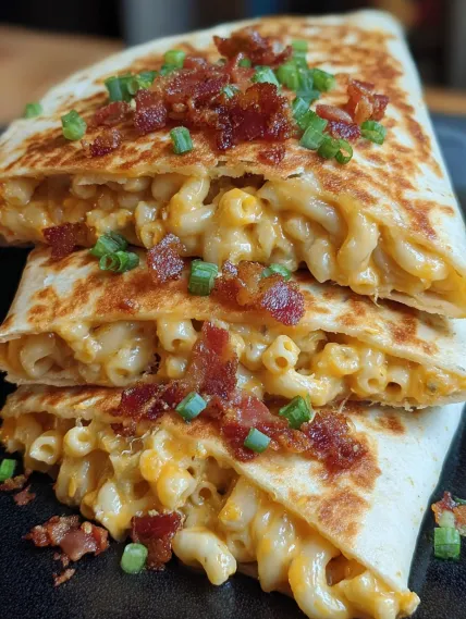A plate of food with bacon and macaroni.