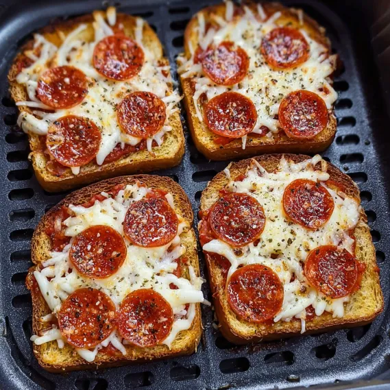 Two slices of pepperoni pizza on a grill.