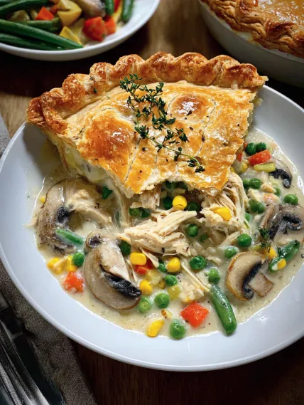 A plate of food with a pie and mushrooms.