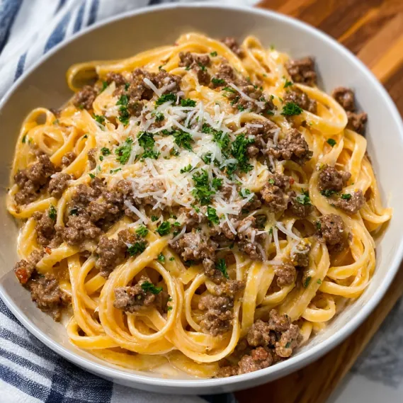 A bowl of pasta with meat and cheese.