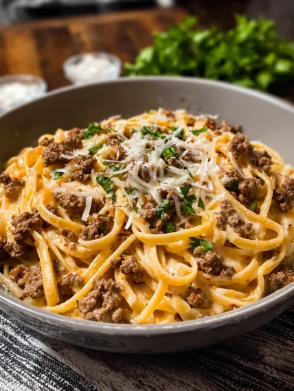 A bowl of pasta with meat and cheese.
