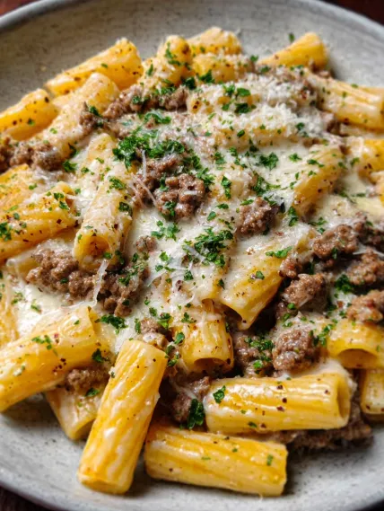 A plate of pasta with meat and cheese.