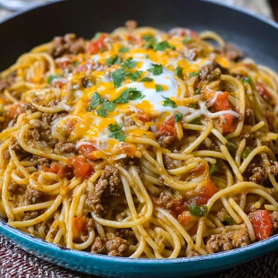 A bowl of spaghetti with meat sauce and cheese.