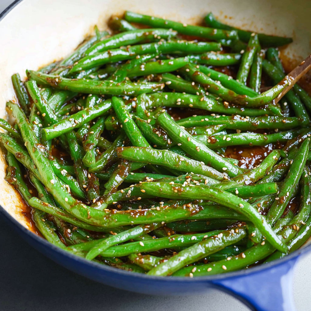 A pan of green beans with miso sauce.