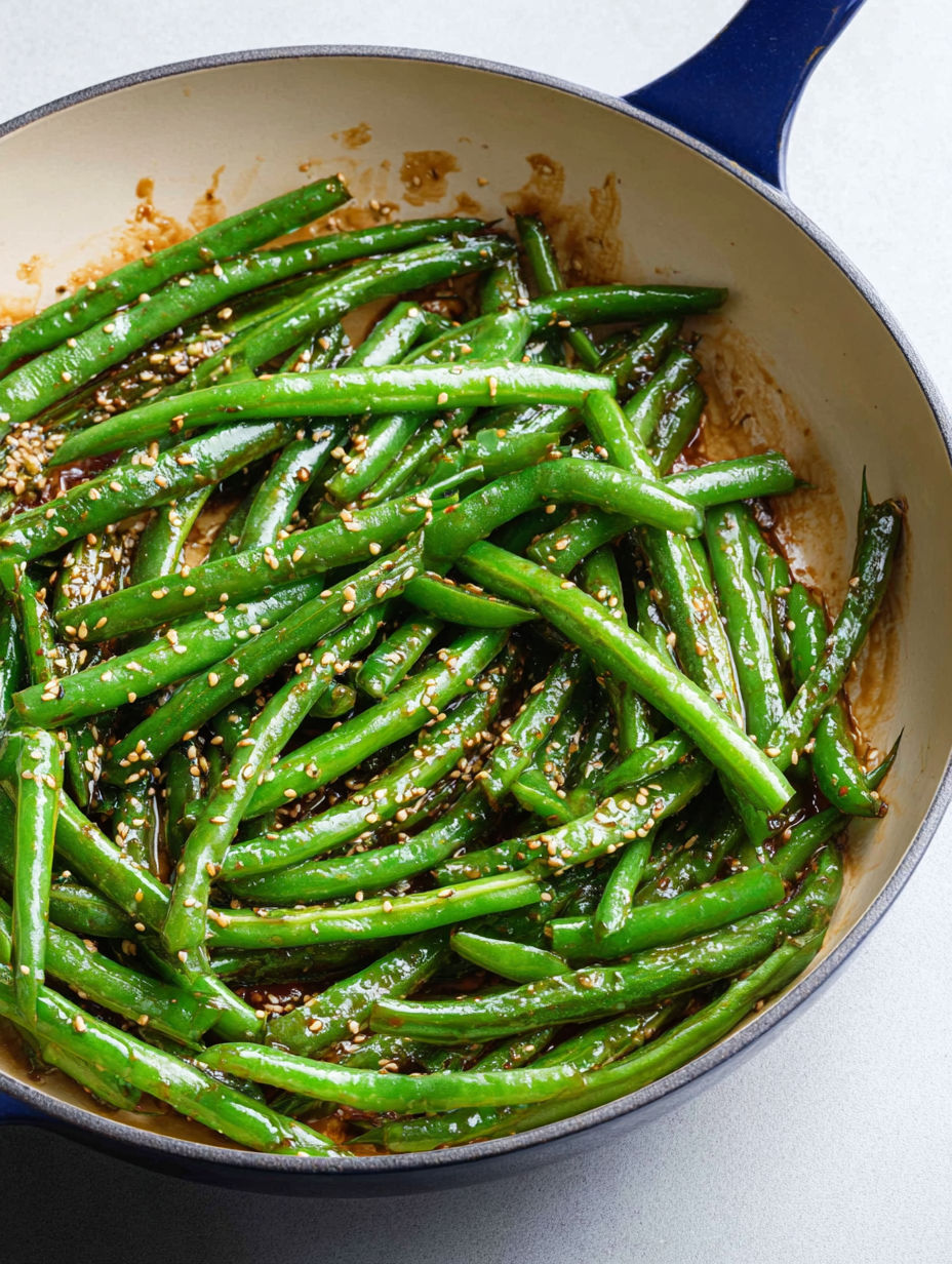 A bowl of green beans with miso sauce.