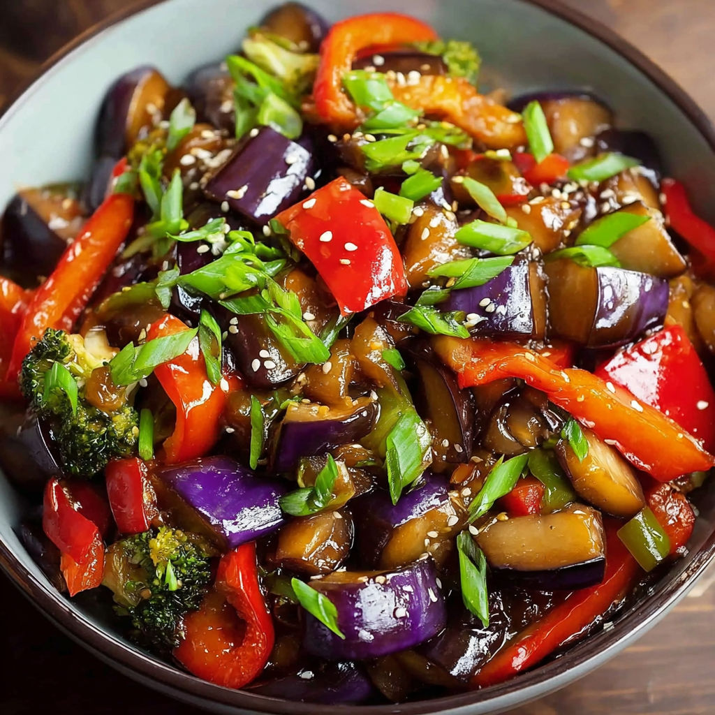 A bowl of stir fry with eggplant, peppers, and broccoli.
