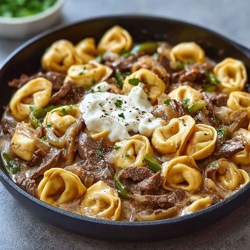 A delicious cheesesteak tortellini provolone skillet.