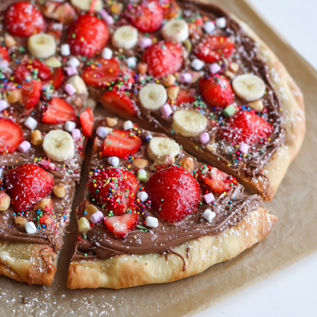 A slice of Nutella pizza with strawberries and bananas.
