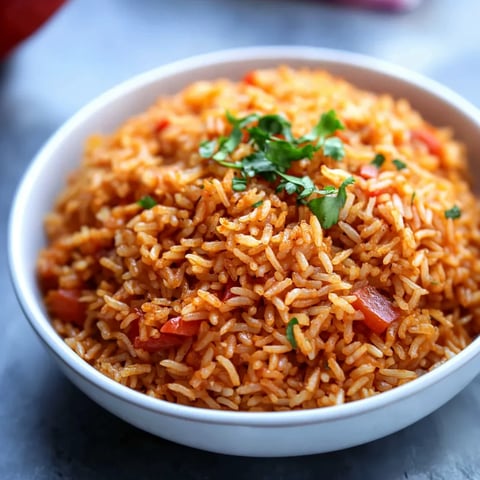 A bowl of rice with vegetables and herbs on top.