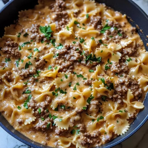 A bowl of pasta with meat and cheese.