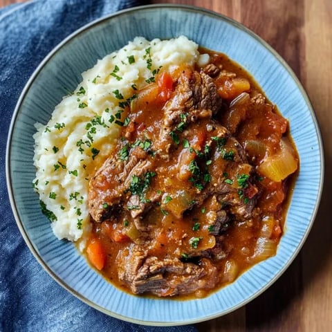 A bowl of meat and potatoes.