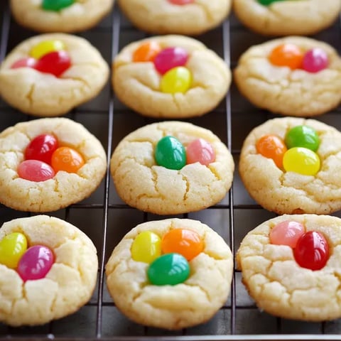 A tray of cookies with different colored candies on top.
