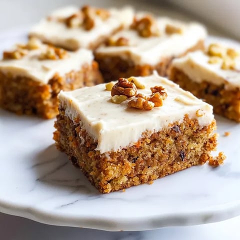 A slice of cake with nuts on top.