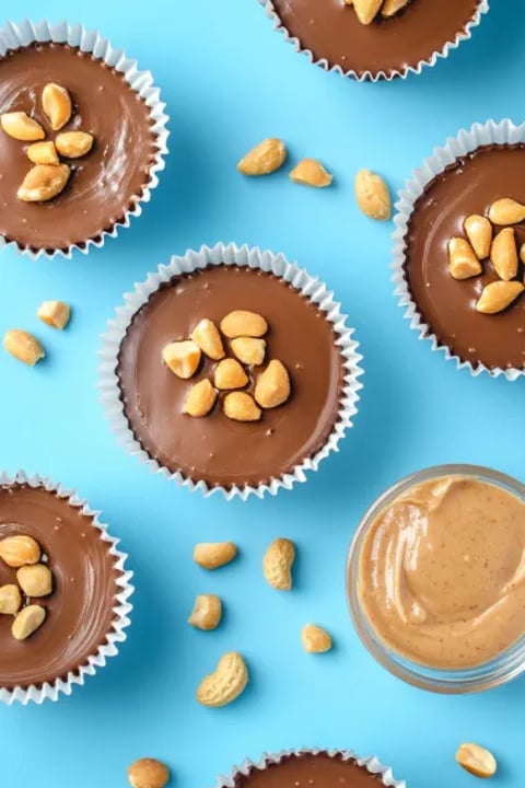 A close up of a chocolate dessert with peanuts on top.