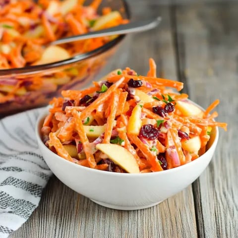 A bowl of carrots and apples.