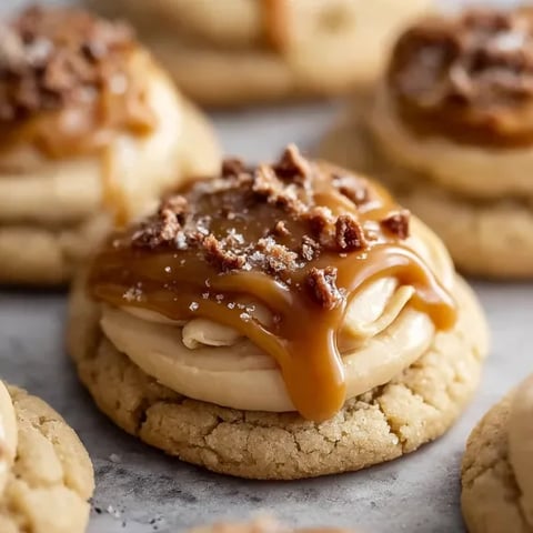 A close up of a cookie with caramel drizzled on top.
