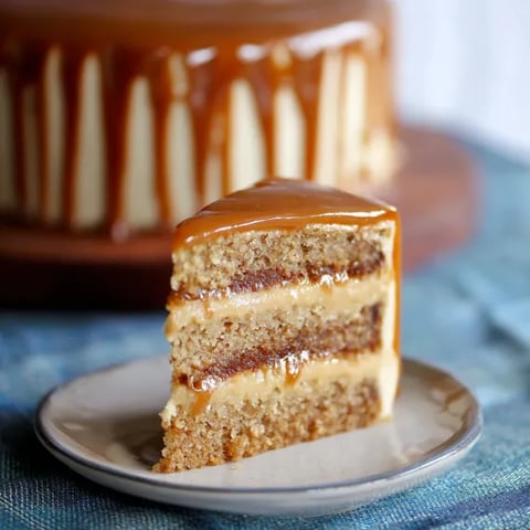 A slice of cake with caramel frosting.
